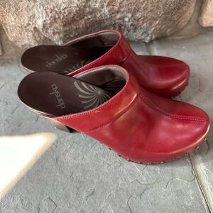 Only worn twice, Dansko Rae clogs. Dark red, wooden heels, brass tacks, Sz 10
